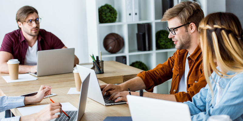 A business owner reviewing steps to hire a web developer for a new project, evaluating skills, criteria, and cooperation models