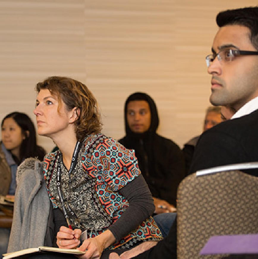Group of young professionals sitting at a seminar.