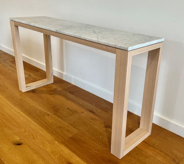 Loop leg console with a Carrara marble top