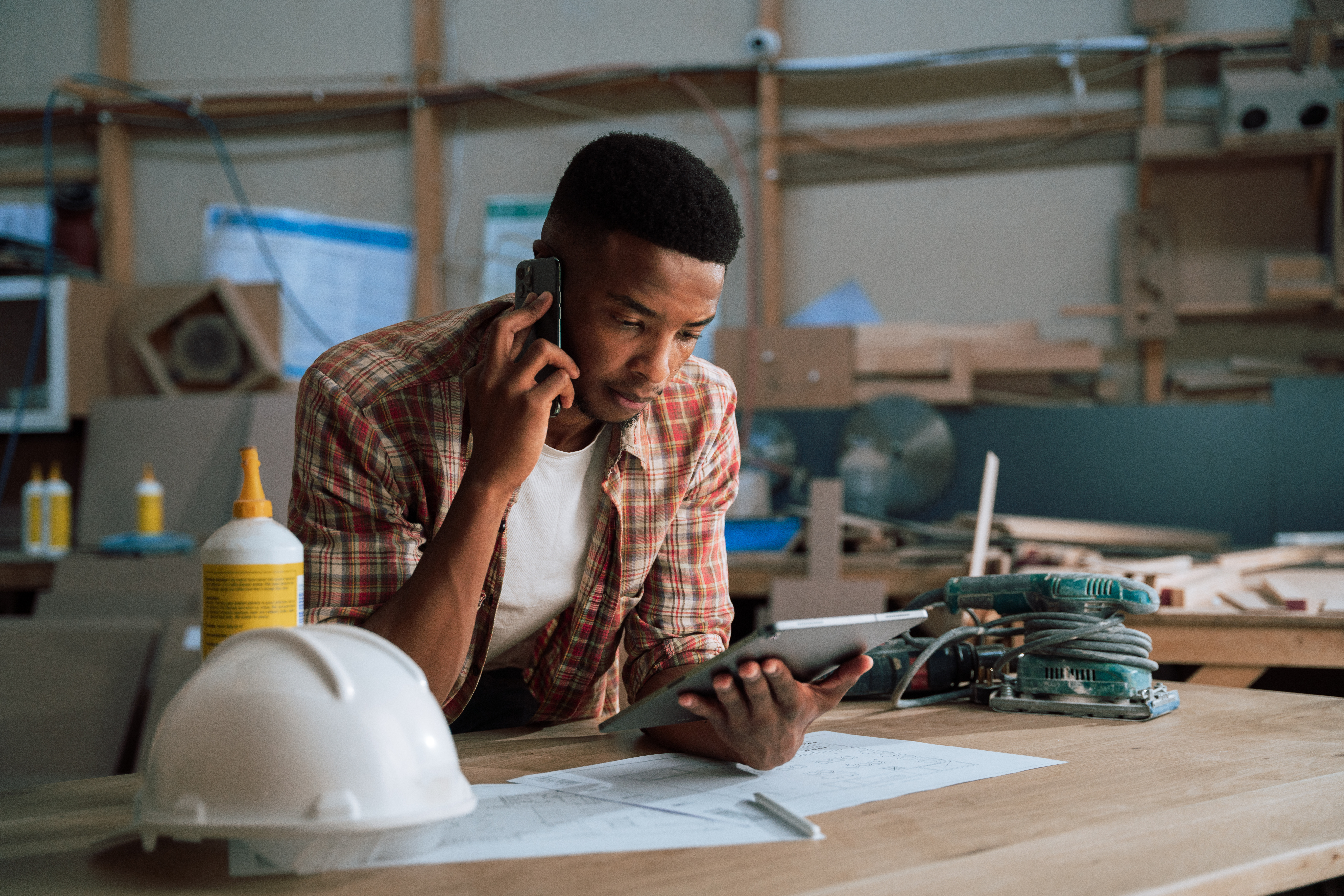 Blue collar man calling clients to follow up