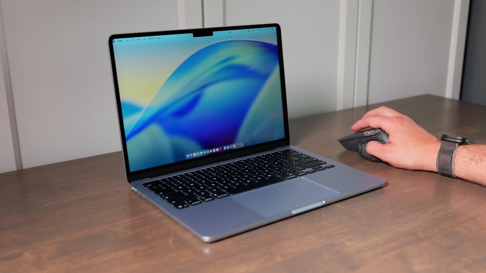 Using the Logitech MX Master 4 next to a MacBook on a desk