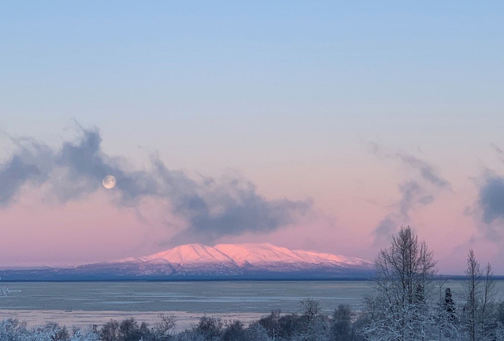 Sunset shines a rose pink light on Mount Susitna