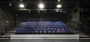 An auditorium full of empty blue seats