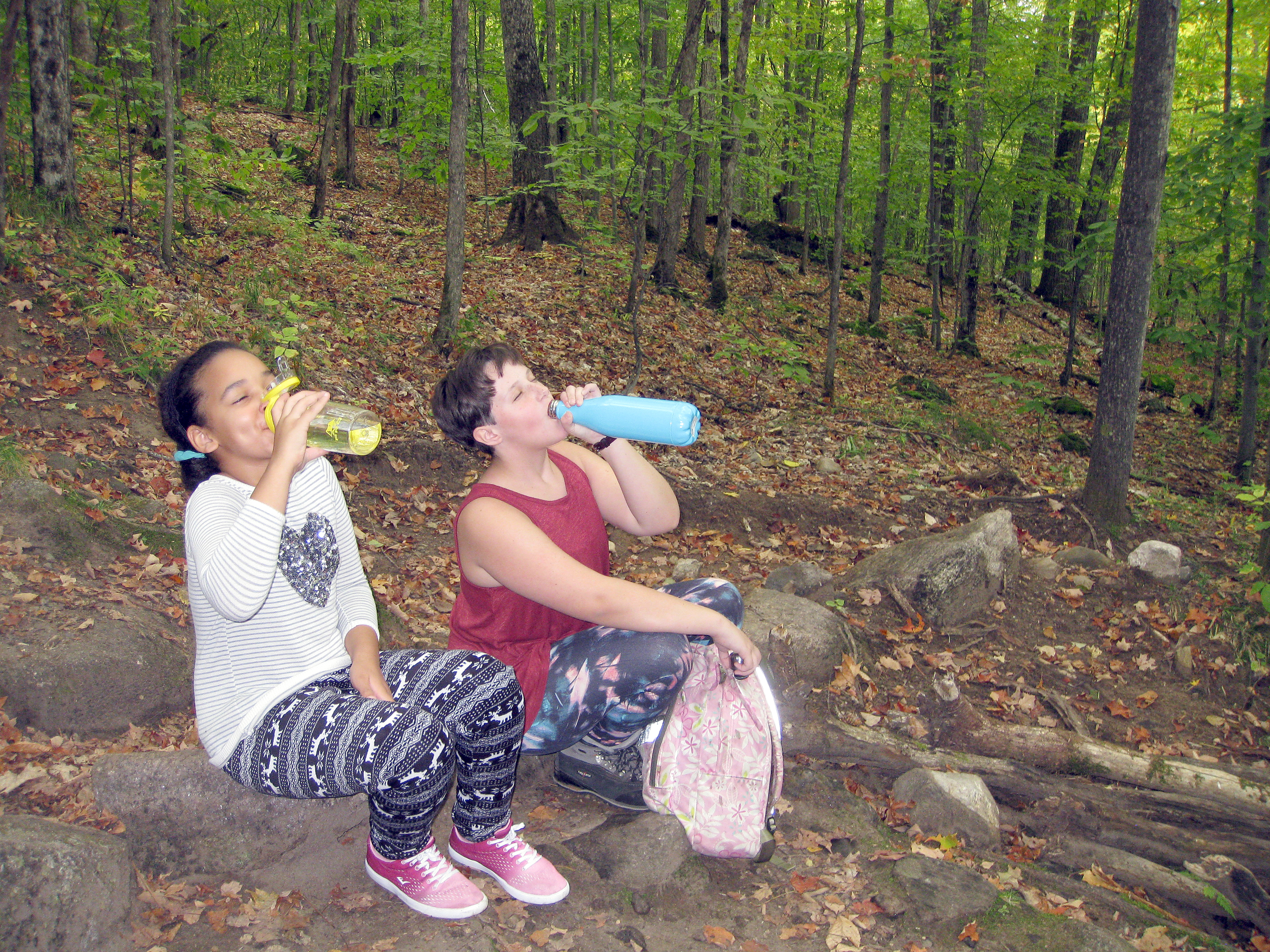 Friends Eniola and Brigid gulp some water halfway up the first climb at Silver Lake Mountain.