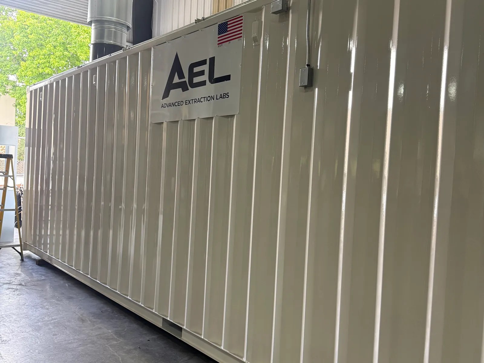 White AEL-branded modular container in a fabrication shop