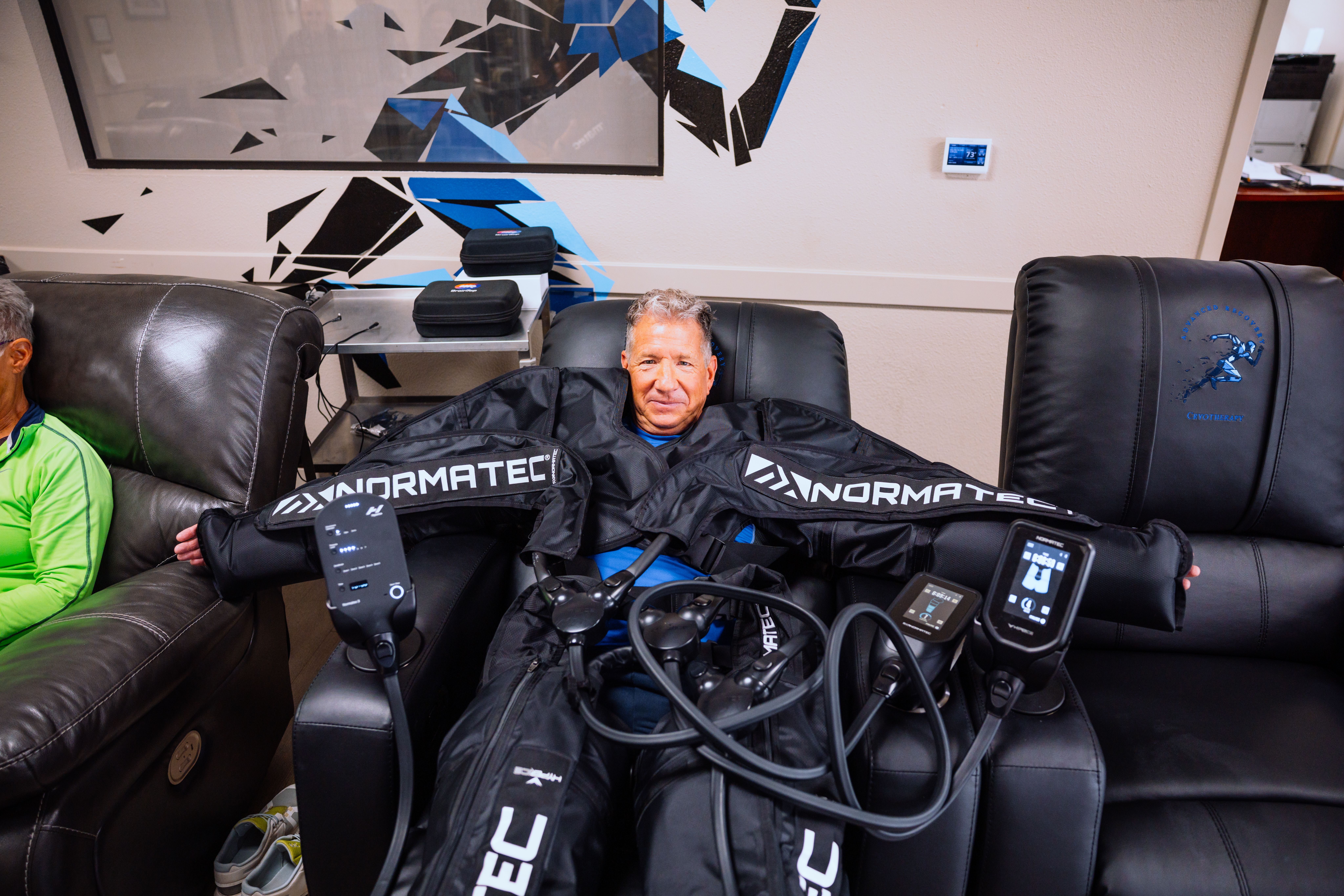Man receiving full-body Normatec compression therapy at Advanced Recovery Cryotherapy.