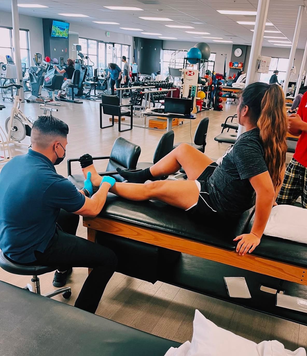 hysical therapist assisting patient with ankle rehabilitation at Advanced Recovery Cryotherapy Modesto.