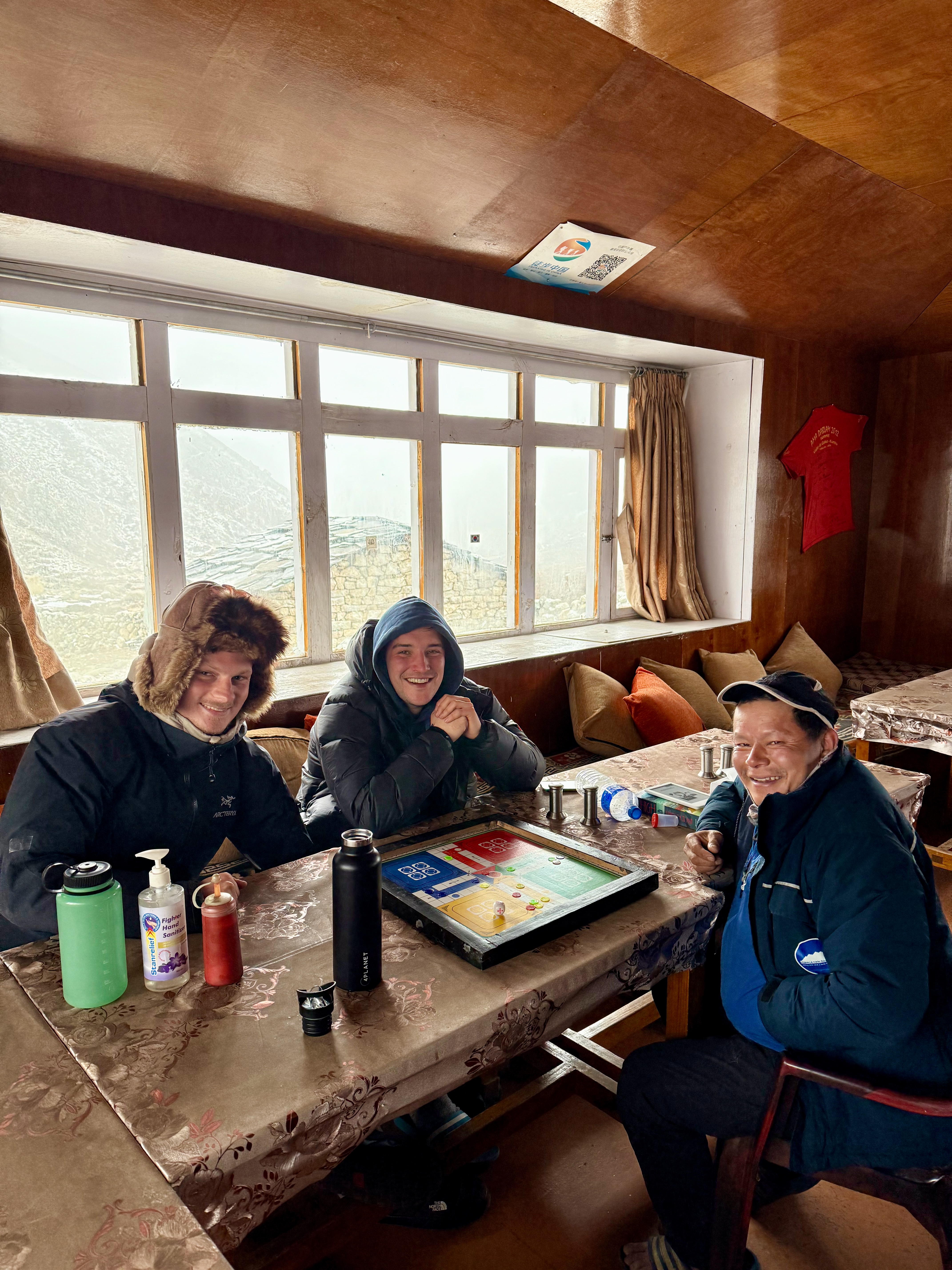 A group of hikers playing Ludo in a teahouse in Nepal.