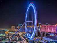 Stunning view of the Las Vegas skyline featuring an illuminated Ferris wheel at night.