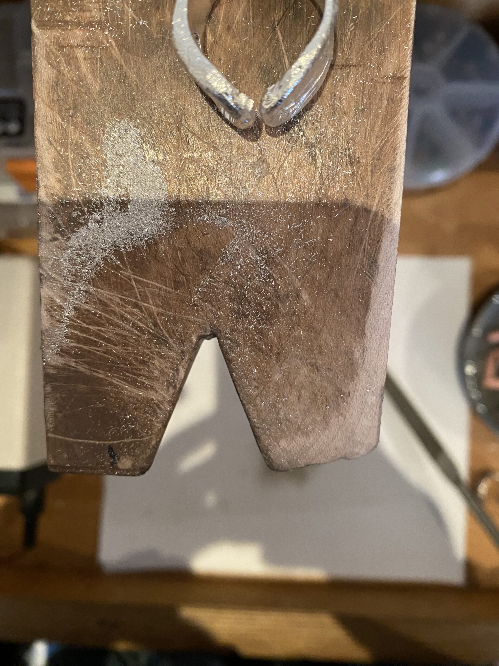 Jewelry designer crafting a sculptural silver piece in the Αιθήρ studio