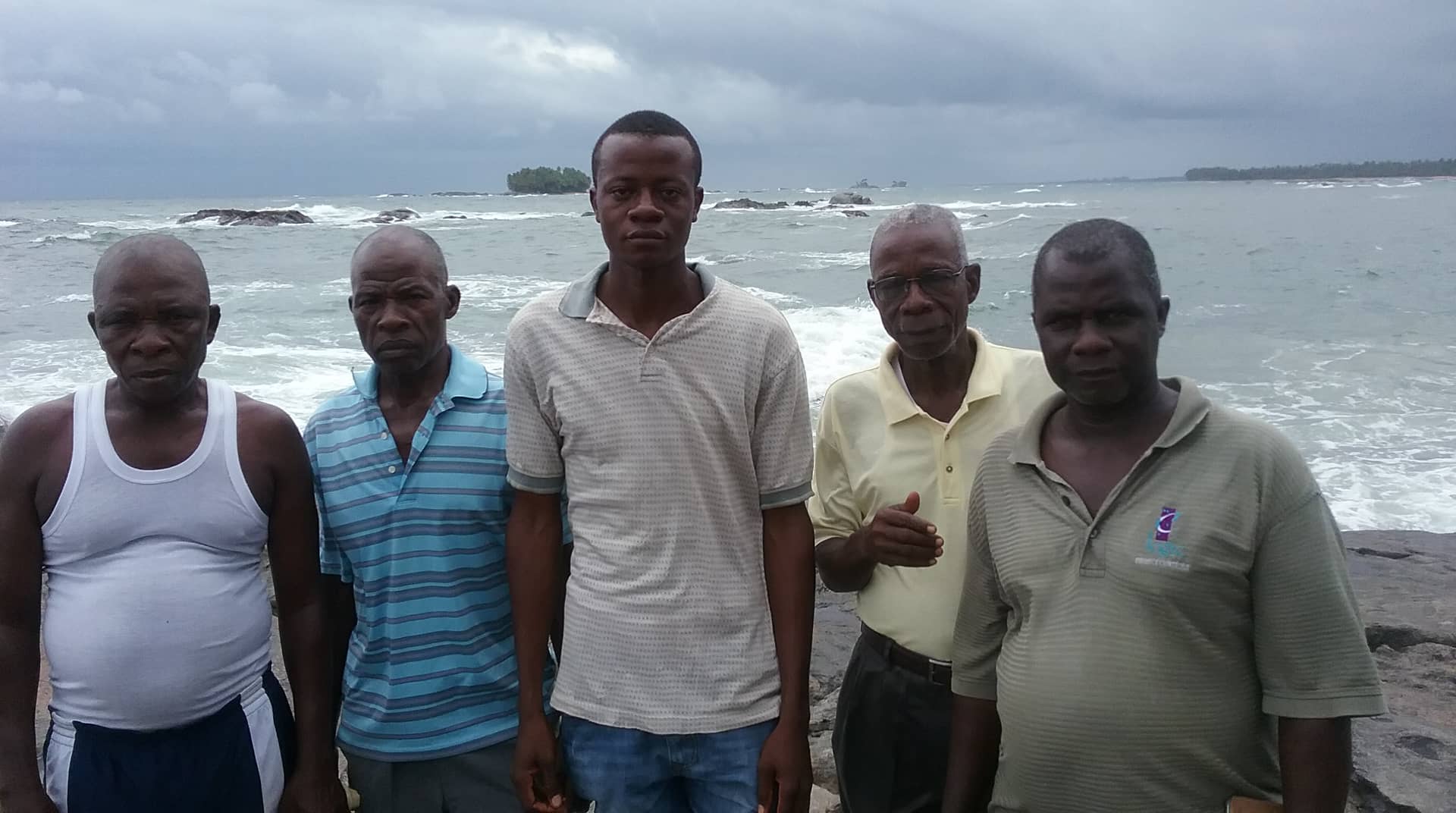 Eric EL2EF in centre with village chief to his right. Behind Eric is Telengbe Island.