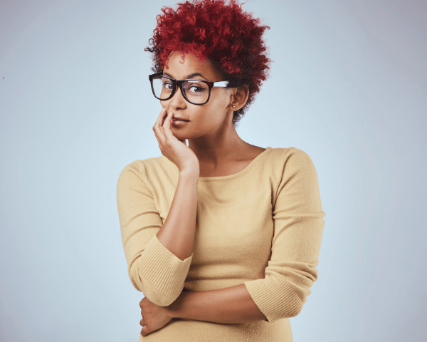 A woman standing wondering if credit is good.