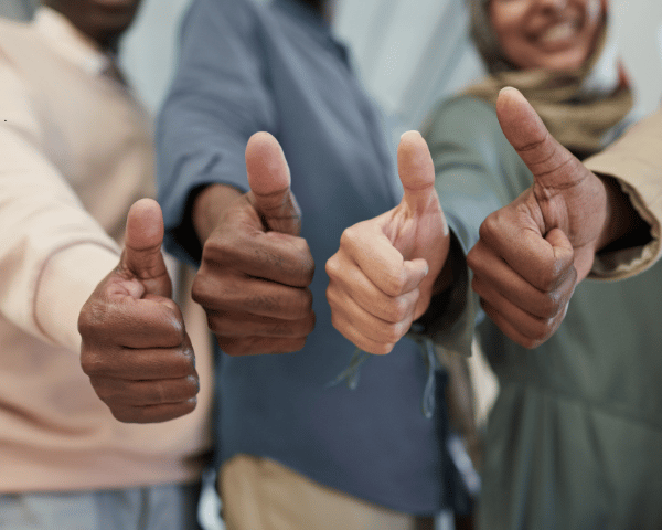 A group of people giving thumbs up letting people know how credit is good.