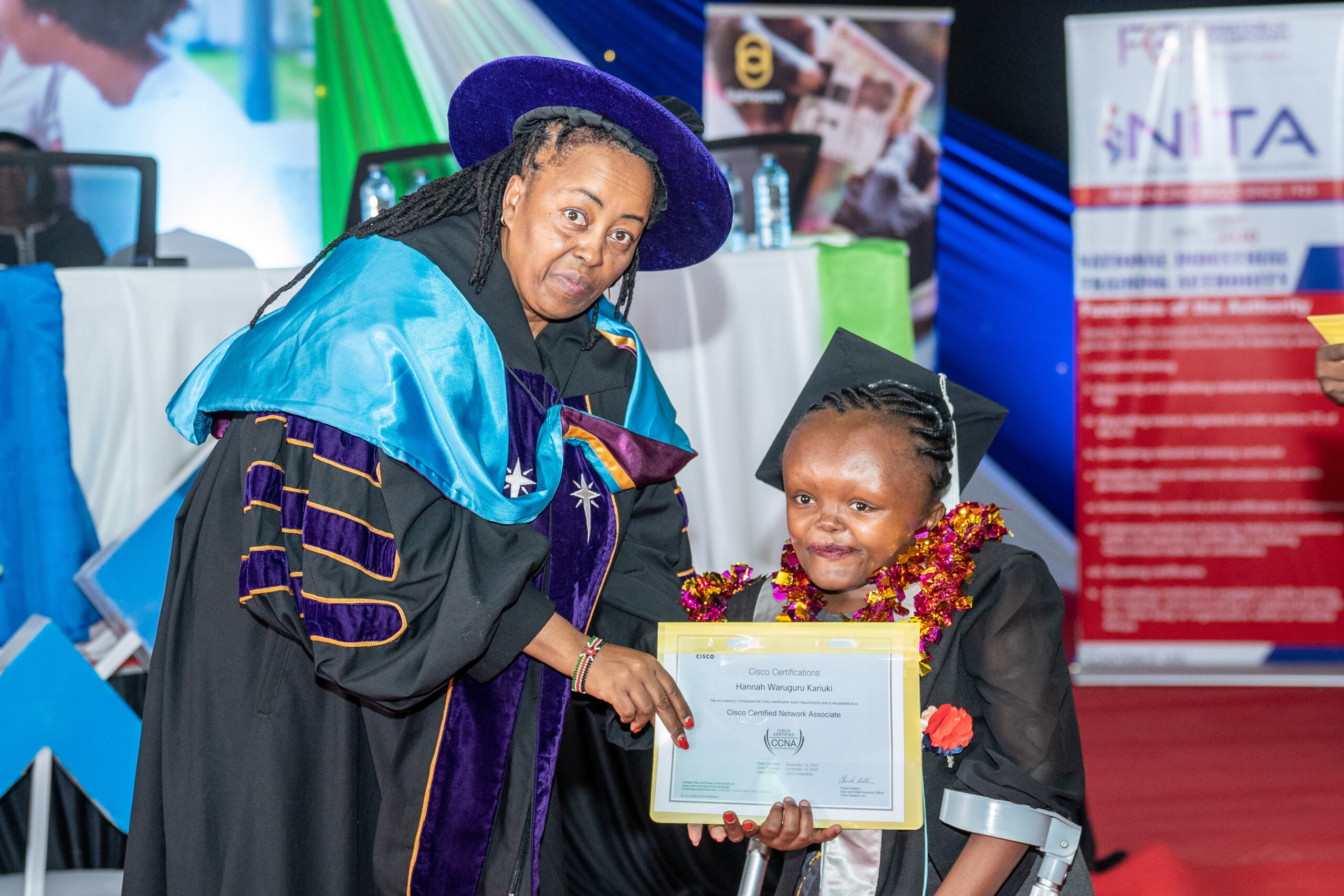 Dr. Wanjiru Kariuki, Secretary, State Department of Labour and Skills Development hands over a certificate to one of the graduates at The Bridge Academy in Nairobi on Feb 29, 2024.