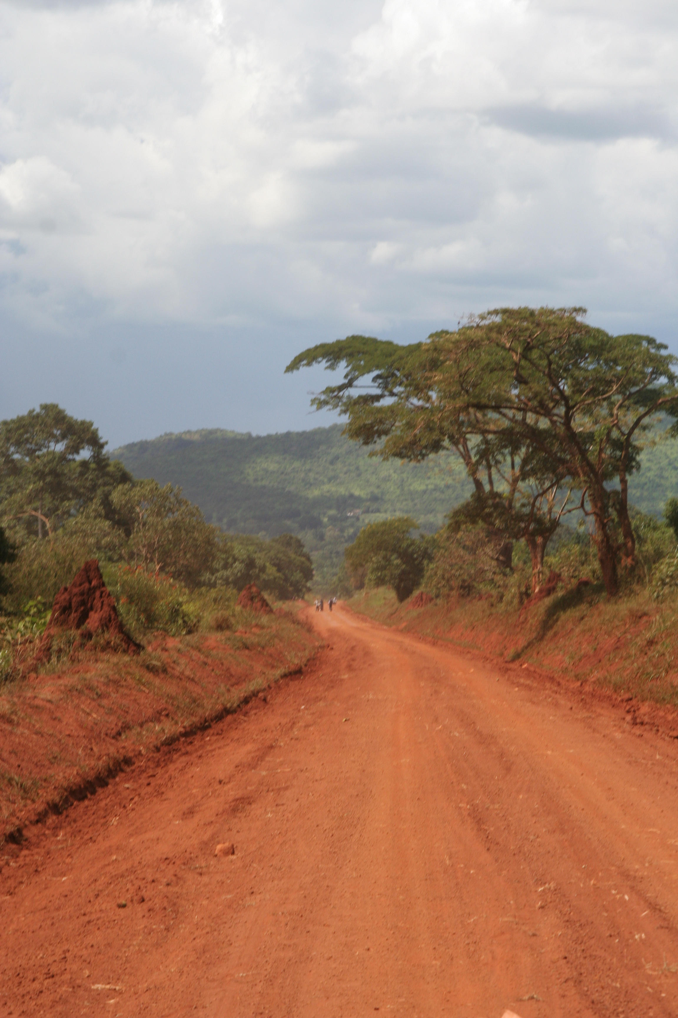 Western Uganda red dirt road and travellers