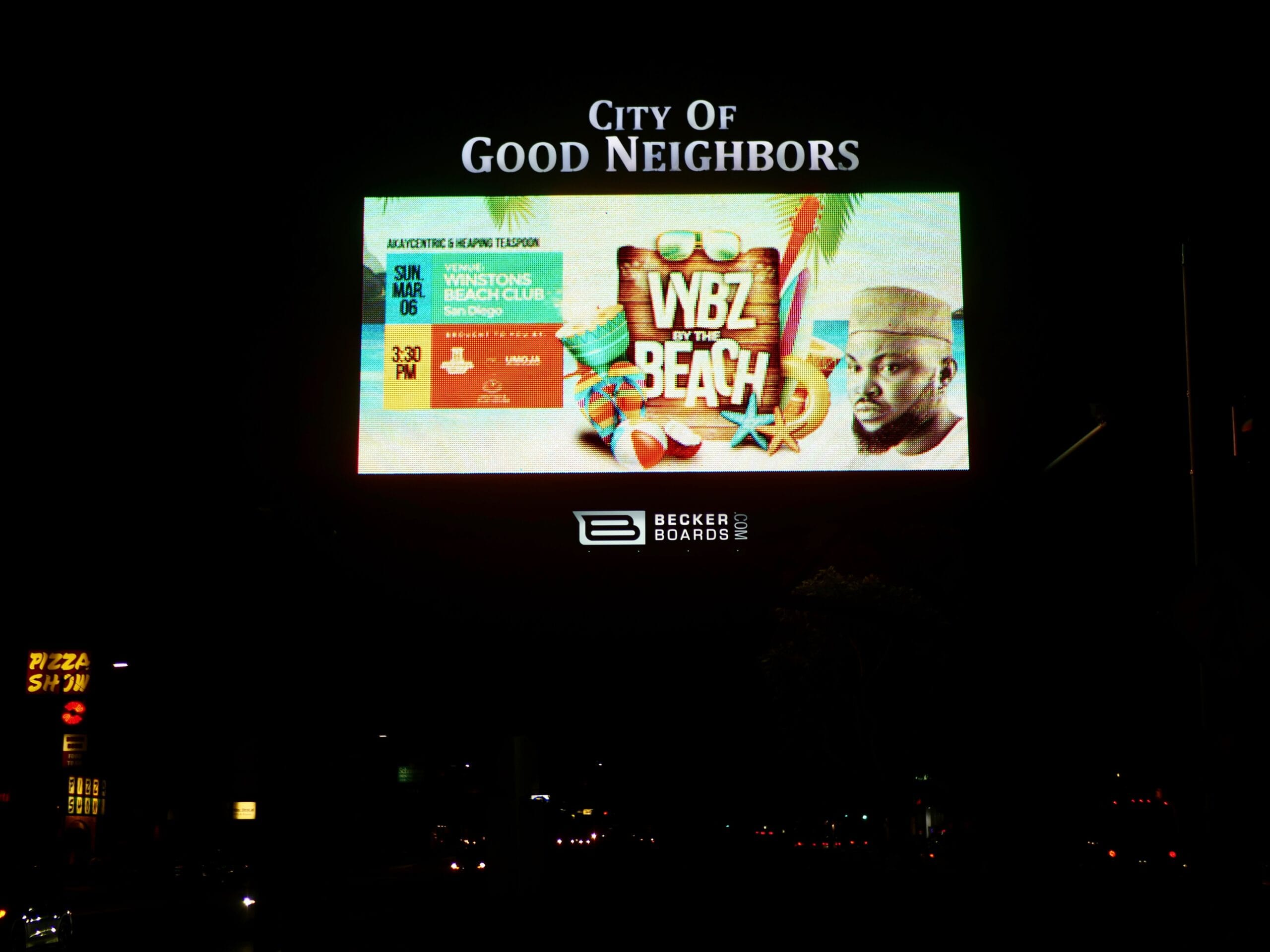 A real Afropanda event ad — WYBZ By The Beach — on a digital billboard at night