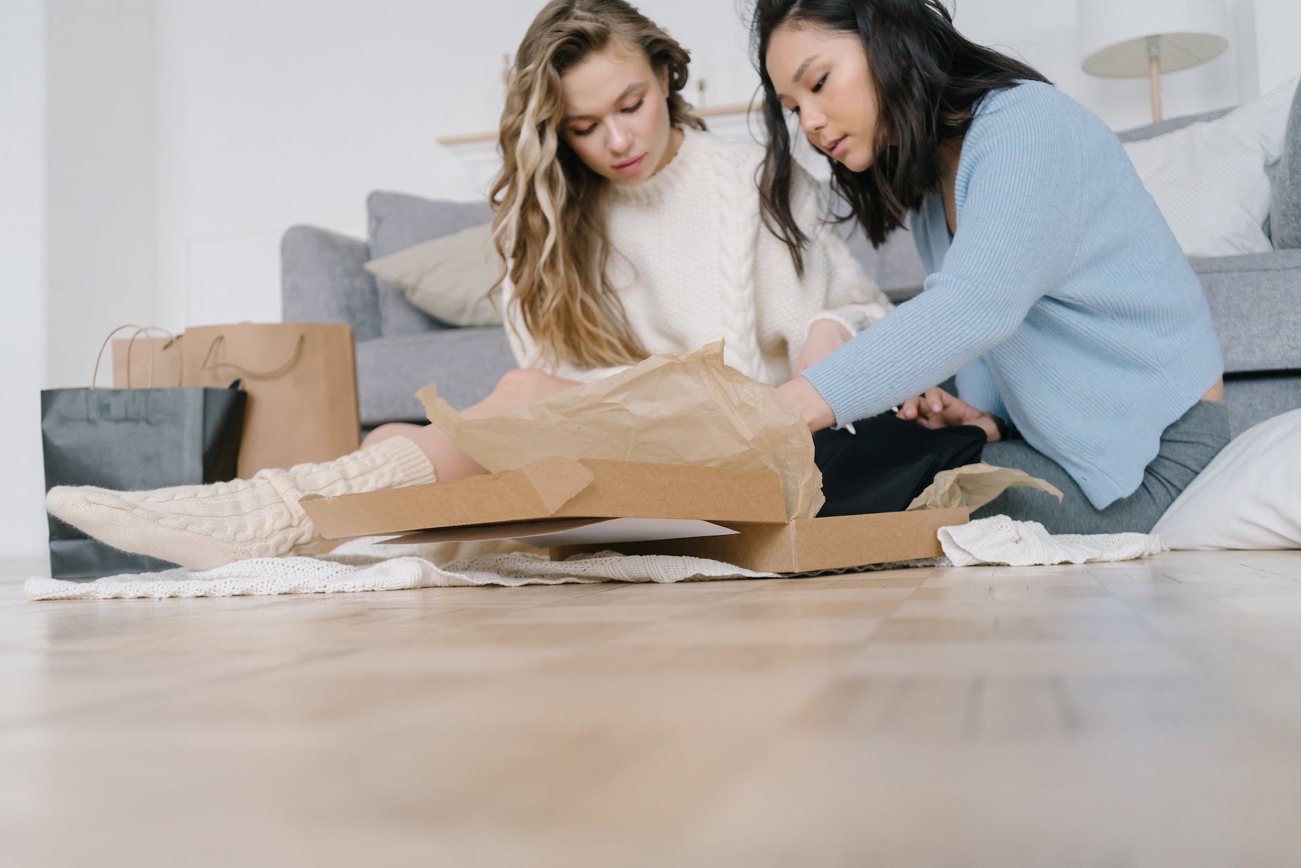 two women opening a box