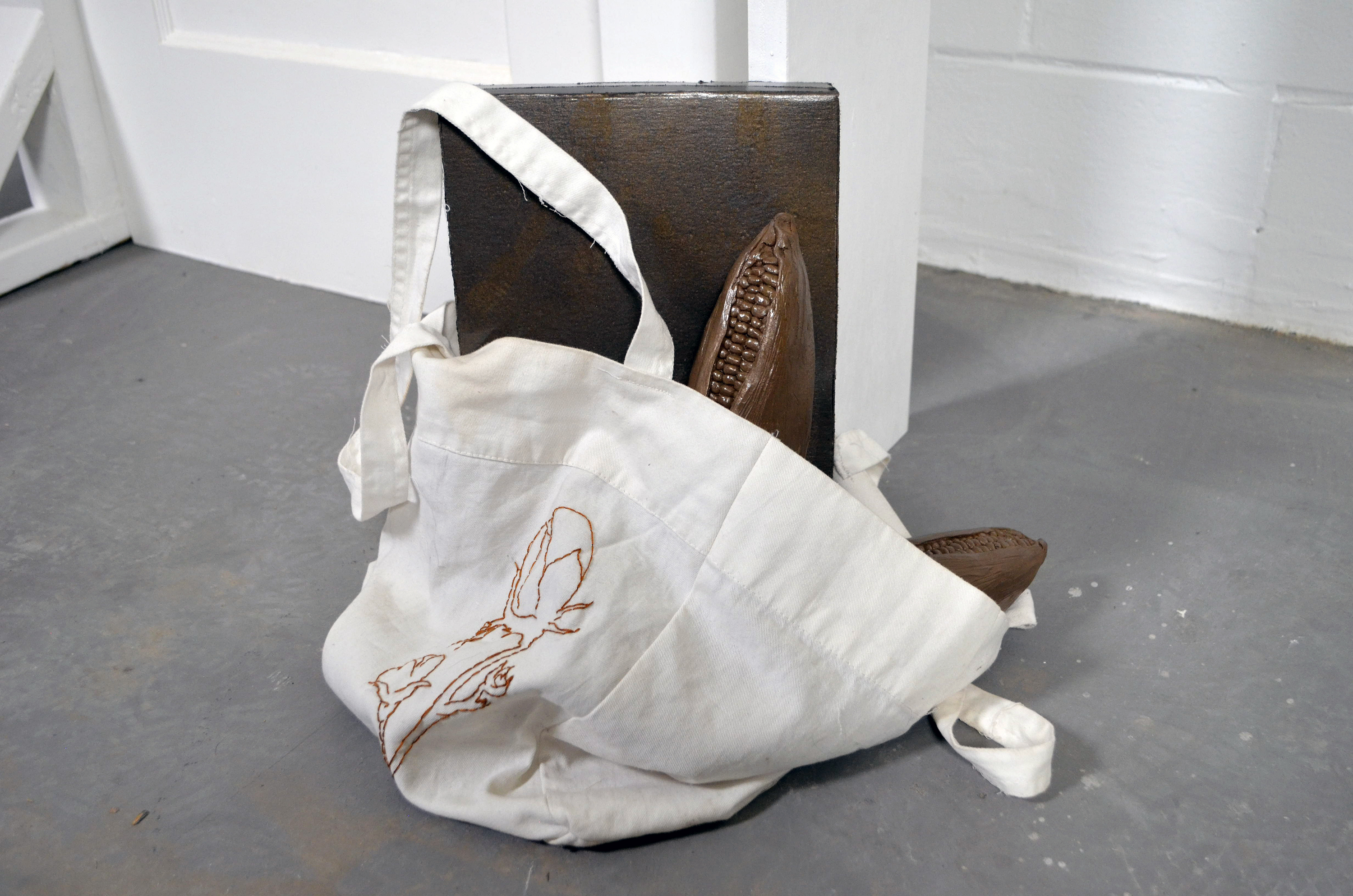 Piece Statement: Over the past couple years there has been an increase of immigration to the US from El Salvador, Honduras, and Guatemala. On a federal level, the US has not received their people well – the opposite can be said about their resources. This installation depicts an entryway scene highlighting the various imports from El Salvador, Honduras, and Guatemala such as: mineral fuels, machinery, electric machinery, cereals (corn), and cotton. This piece brings into question the US’s continuing ironic and exploitative treatment towards immigrants and refugees.