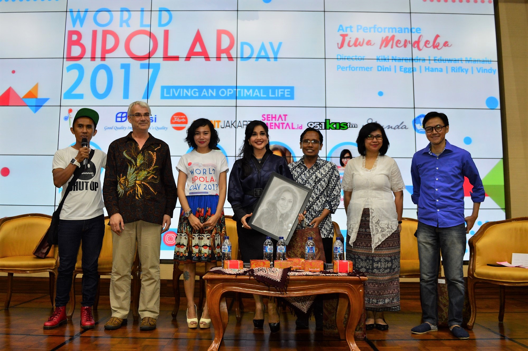 Some people standing on stage of World Bipolar Day event