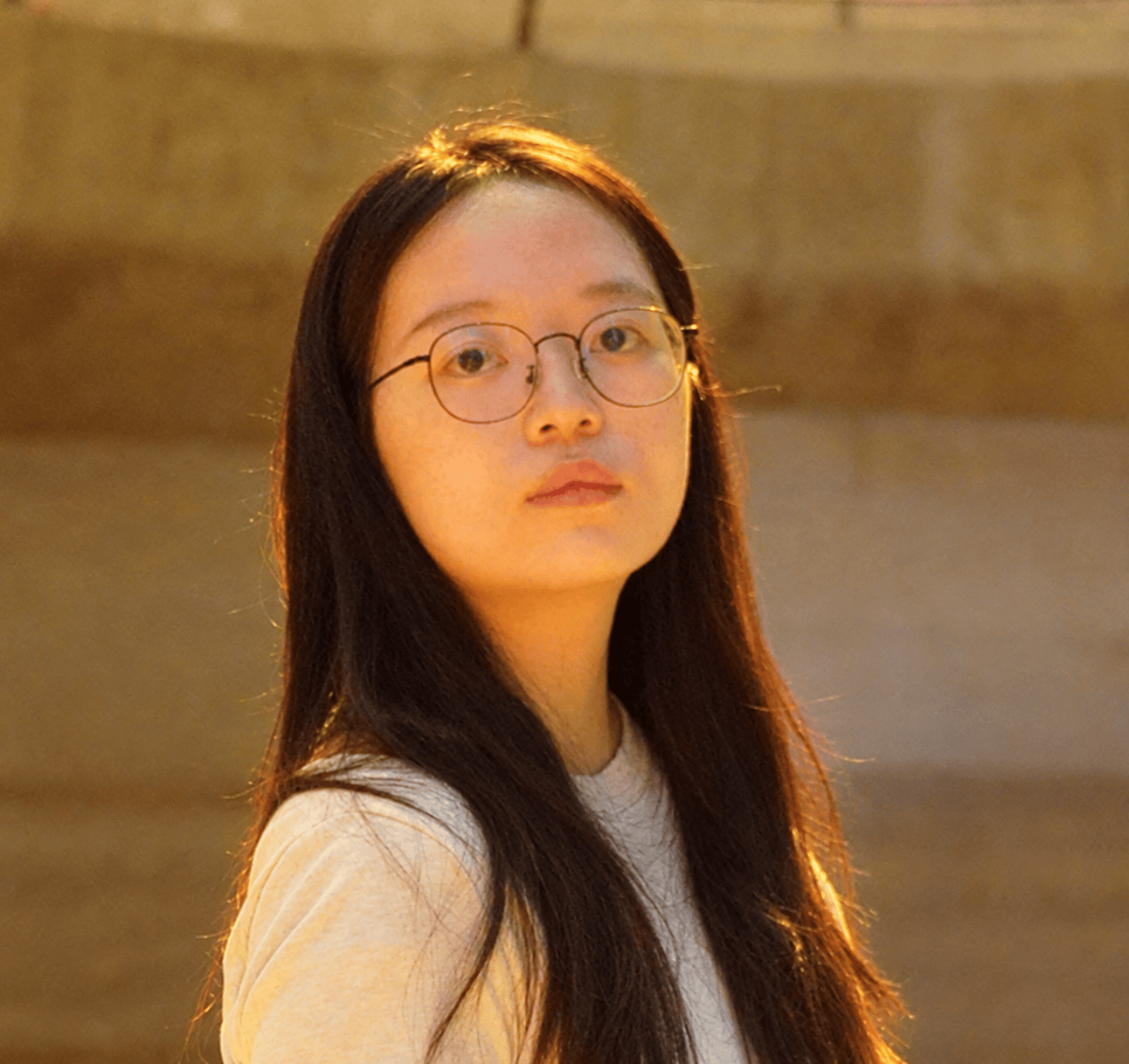 Asian woman with long black hear and glasses.