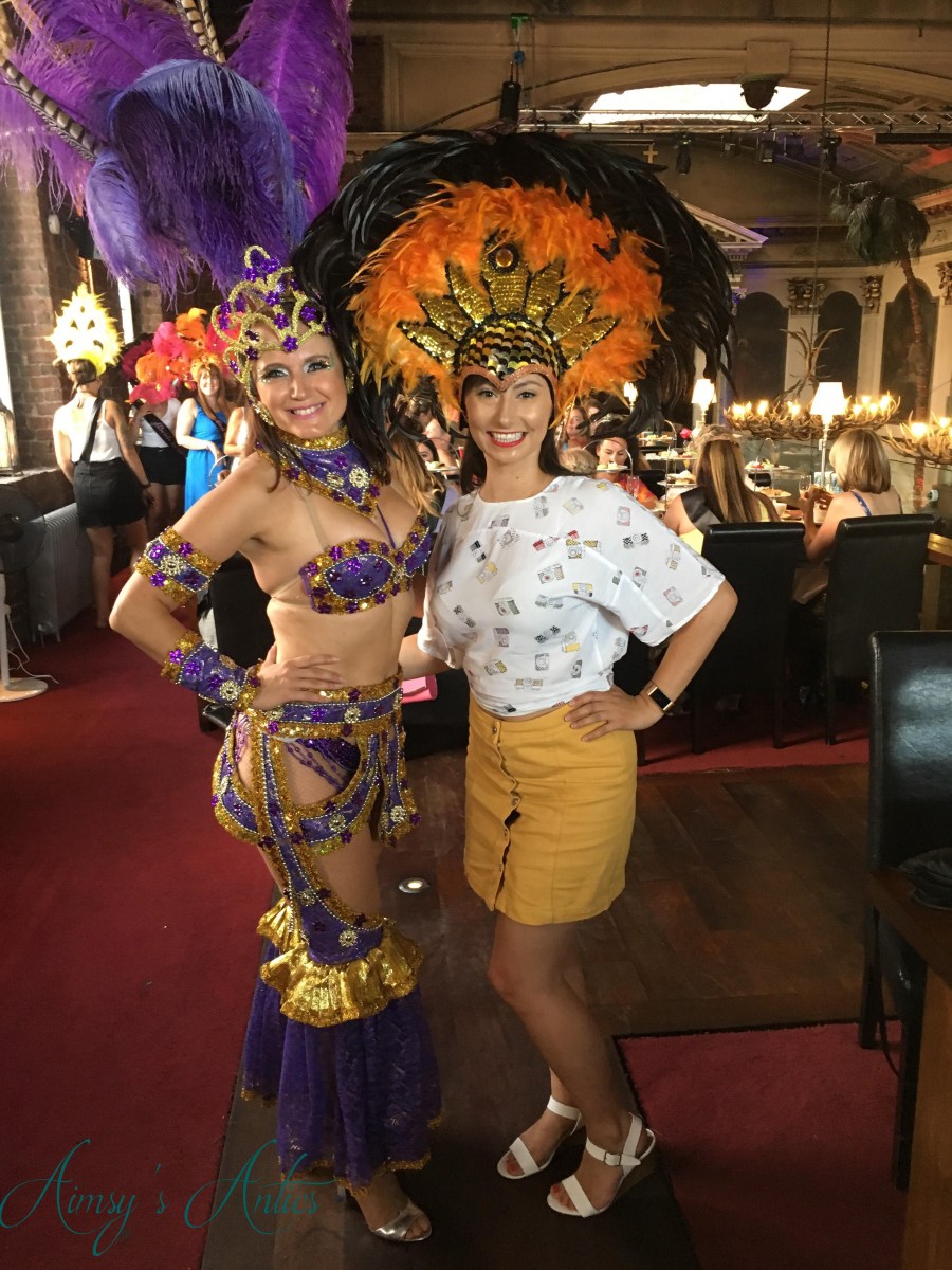Samba dancer posing with other woman wearing headdress