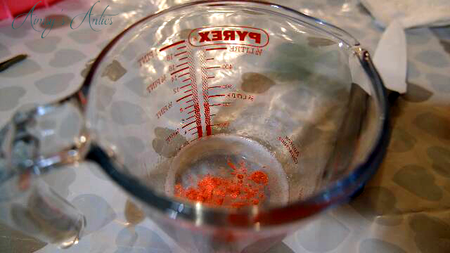 Adding orange mica powder to melted clear soap base