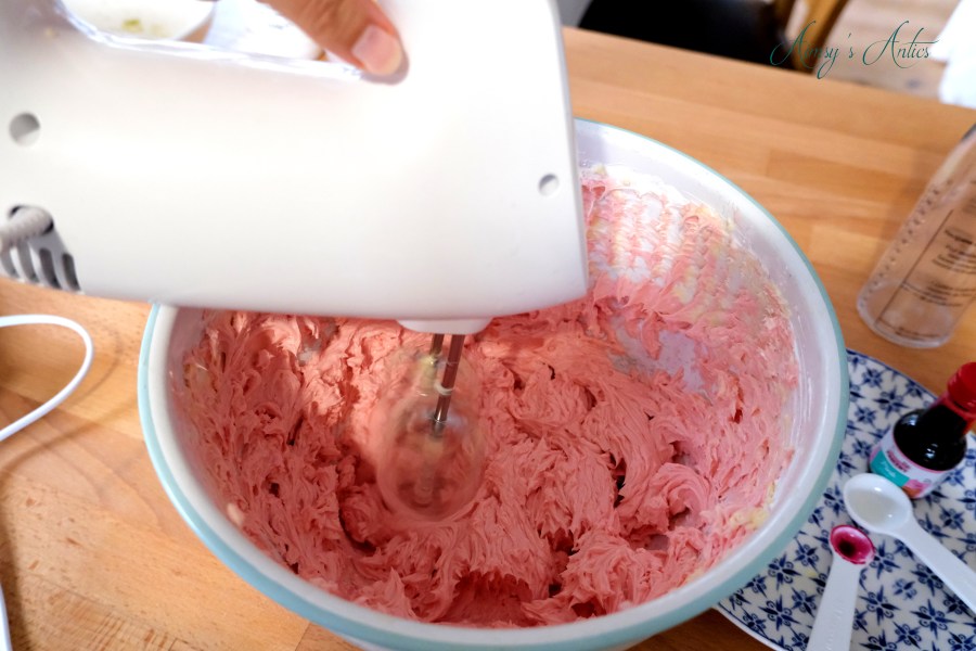 Adding pink colouring to the swiss meringue butter cream