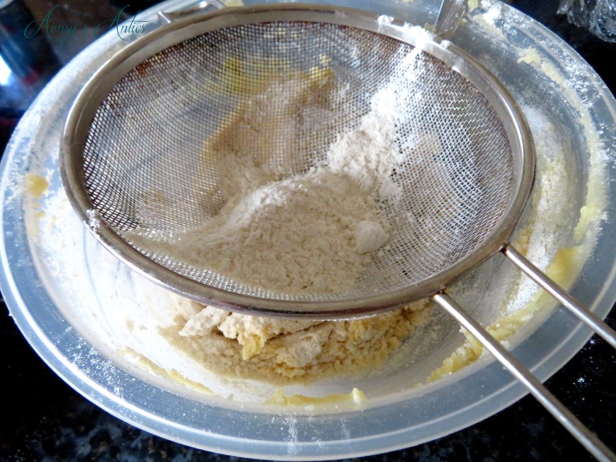 Adding flour to the creamed butter and sugar