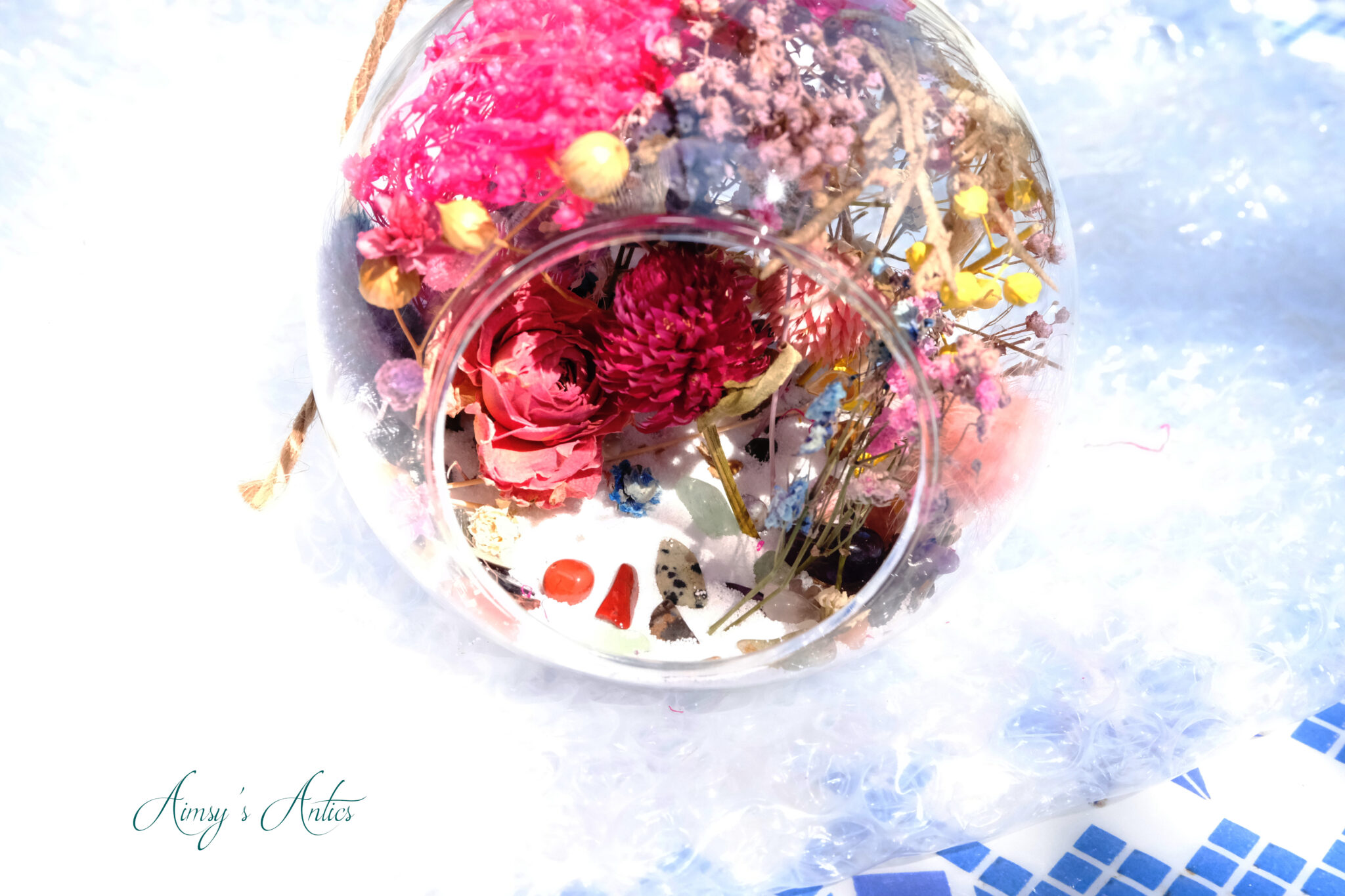 Dried flowers added to the terrarium glass globe