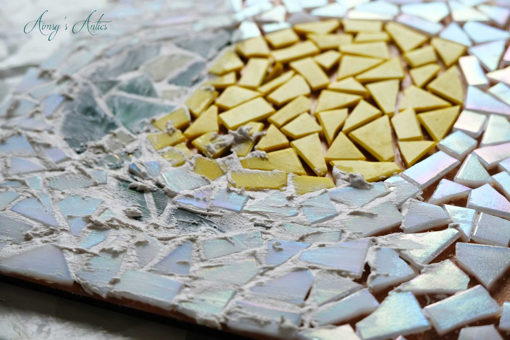 Grout being added to complete the mosaic