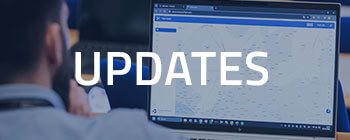 Banner with text “UPDATES” over blurred background of person viewing aviation software on laptop screen.