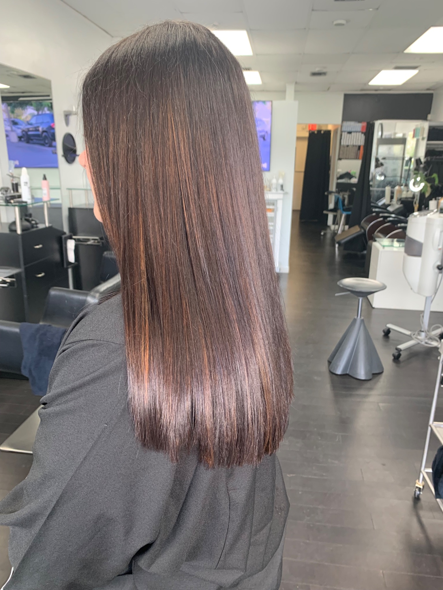 Finished long brunette hair with a smooth polished surface and clean ends at Albert Robin Salon.