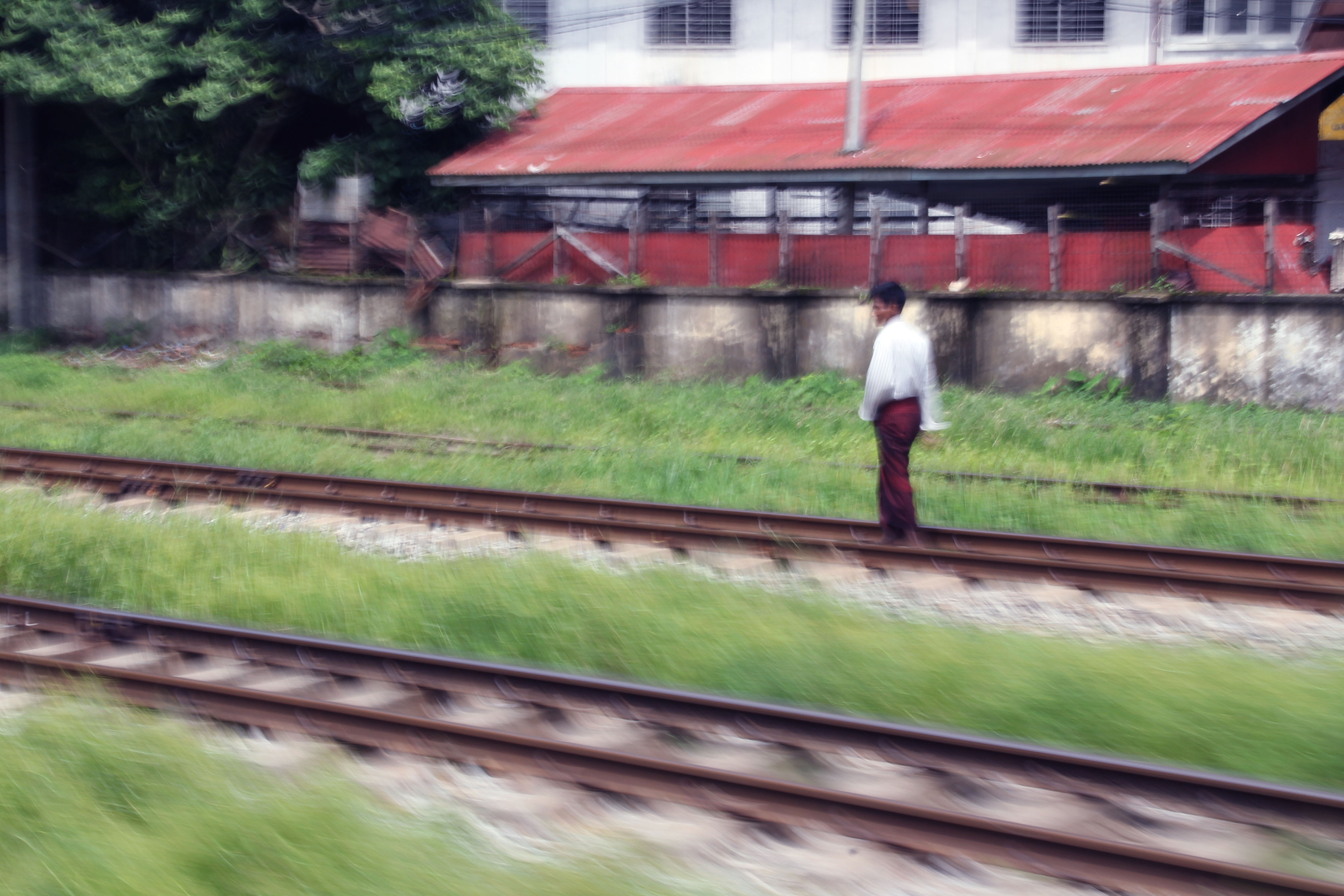 Man sauntering on the circular railway tracks.