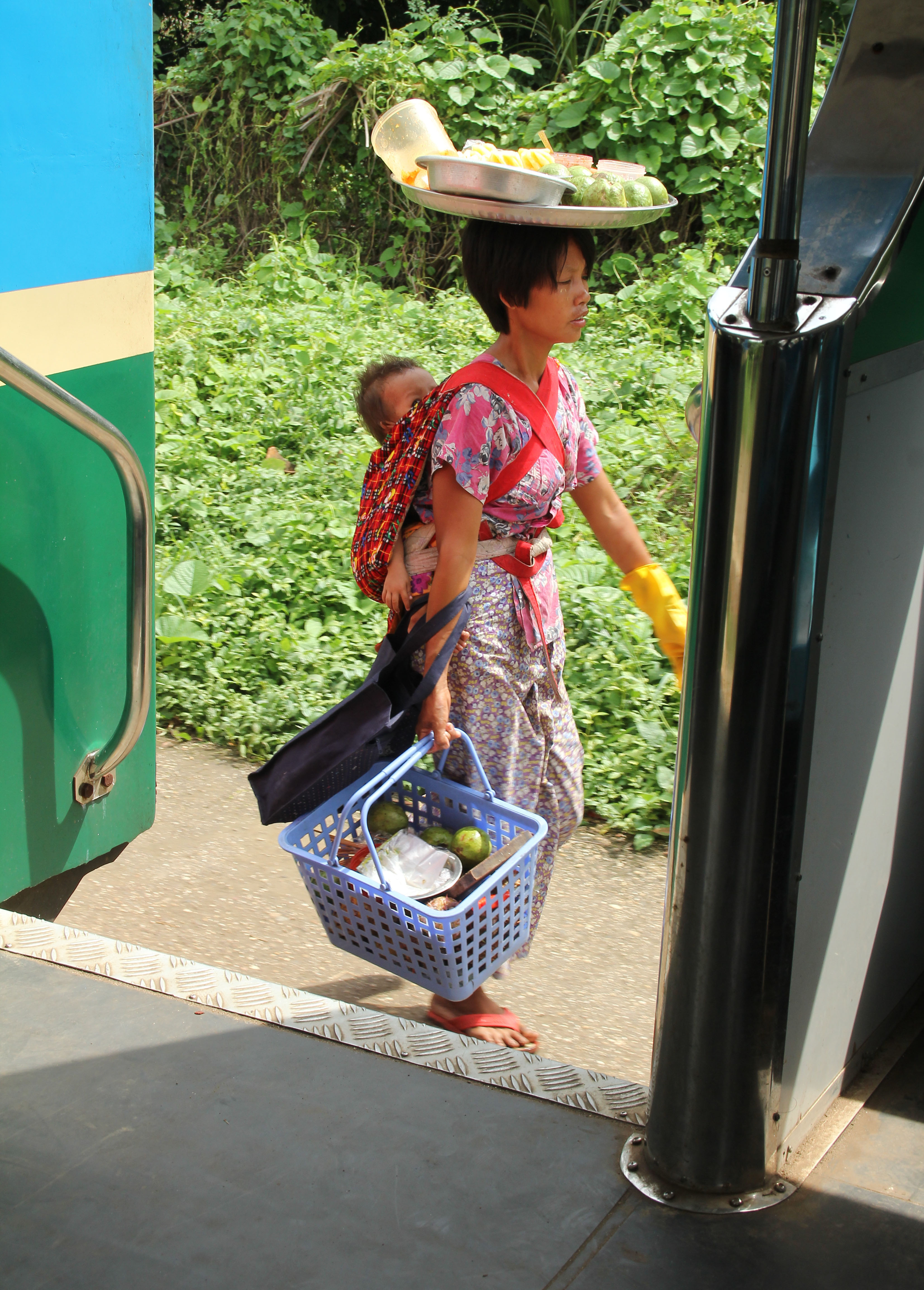 A villager spotted from the train. The train serves the suburban area of Yangon, mostly utilized by lower income families in inner Yangon.