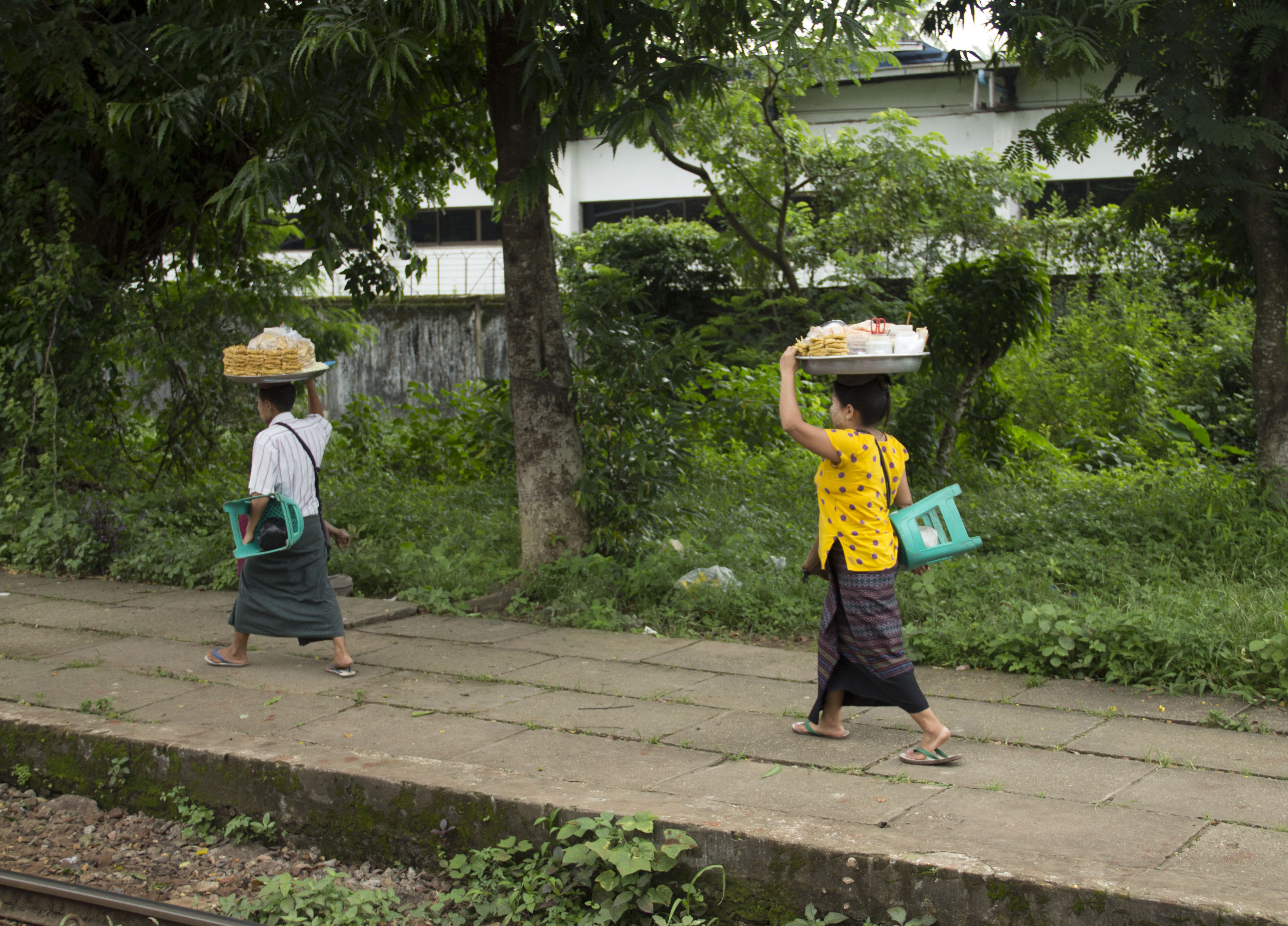 Villagers done shopping from street vendors along Circular Railway route.