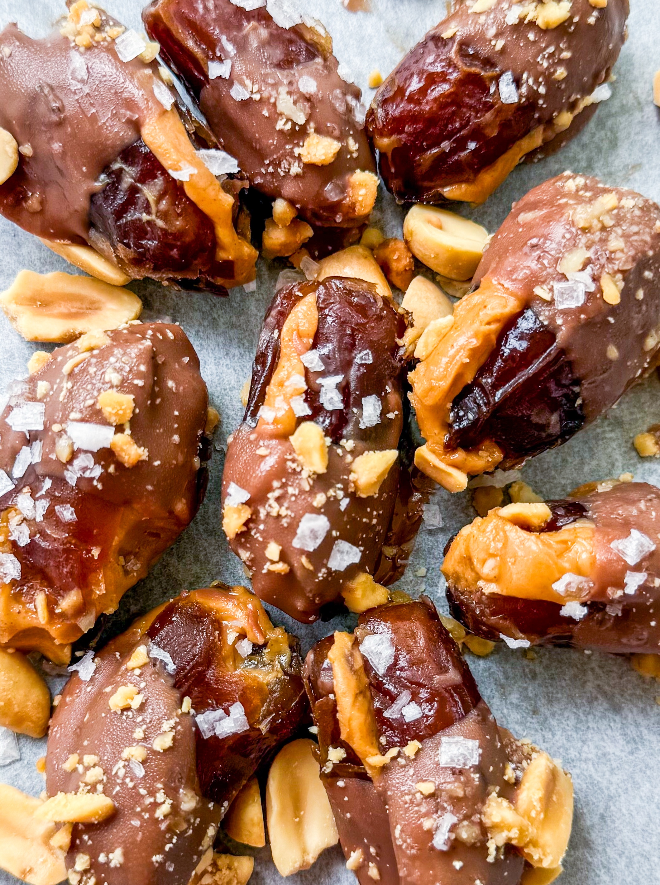 Date Snickers - Date stuffed with peanut buttered drizzled with chocolate and topped with chocolate peanuts and sea salt
