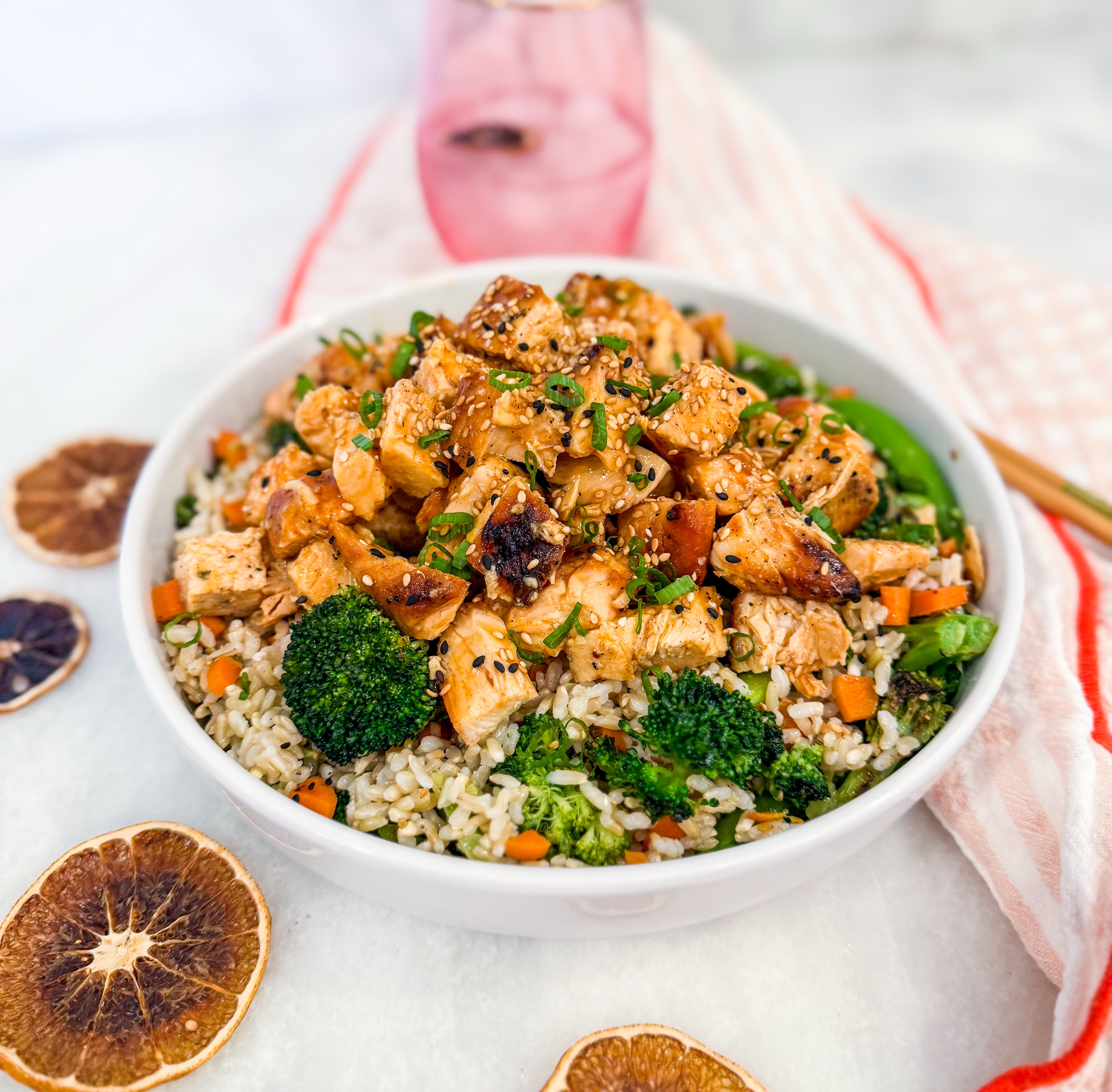 Eat Fit Orange Chicken Bowl - Orange ginger grilled chicken over brown rice with roasted broccoli, carrots, snap peas, scallions, sesame, and citrus soy glaze