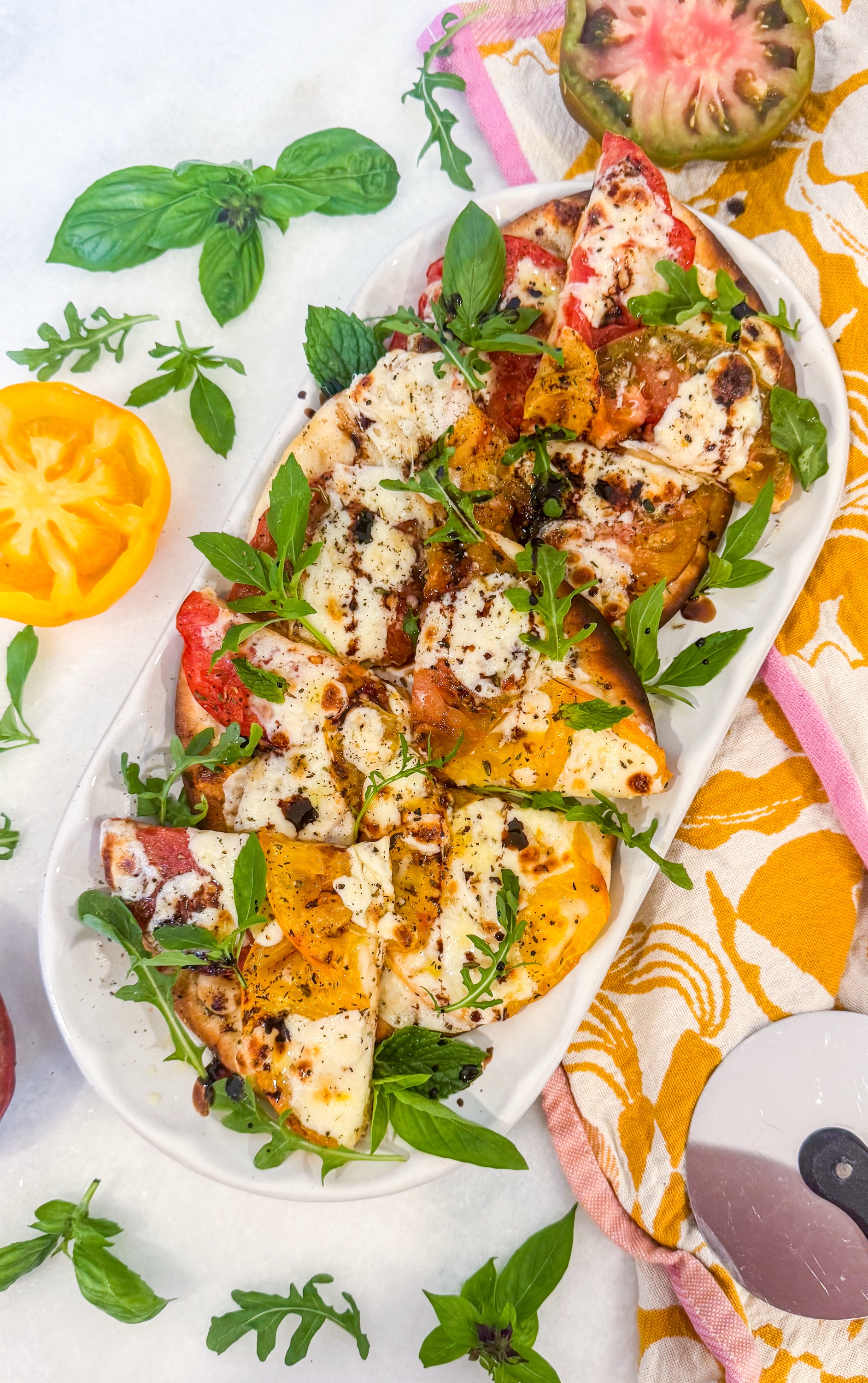 Harvest Tomato Flatbread - Roasted tomatoes, mozzarella, parmesan, arugula, basil, mint and balsamic reduction