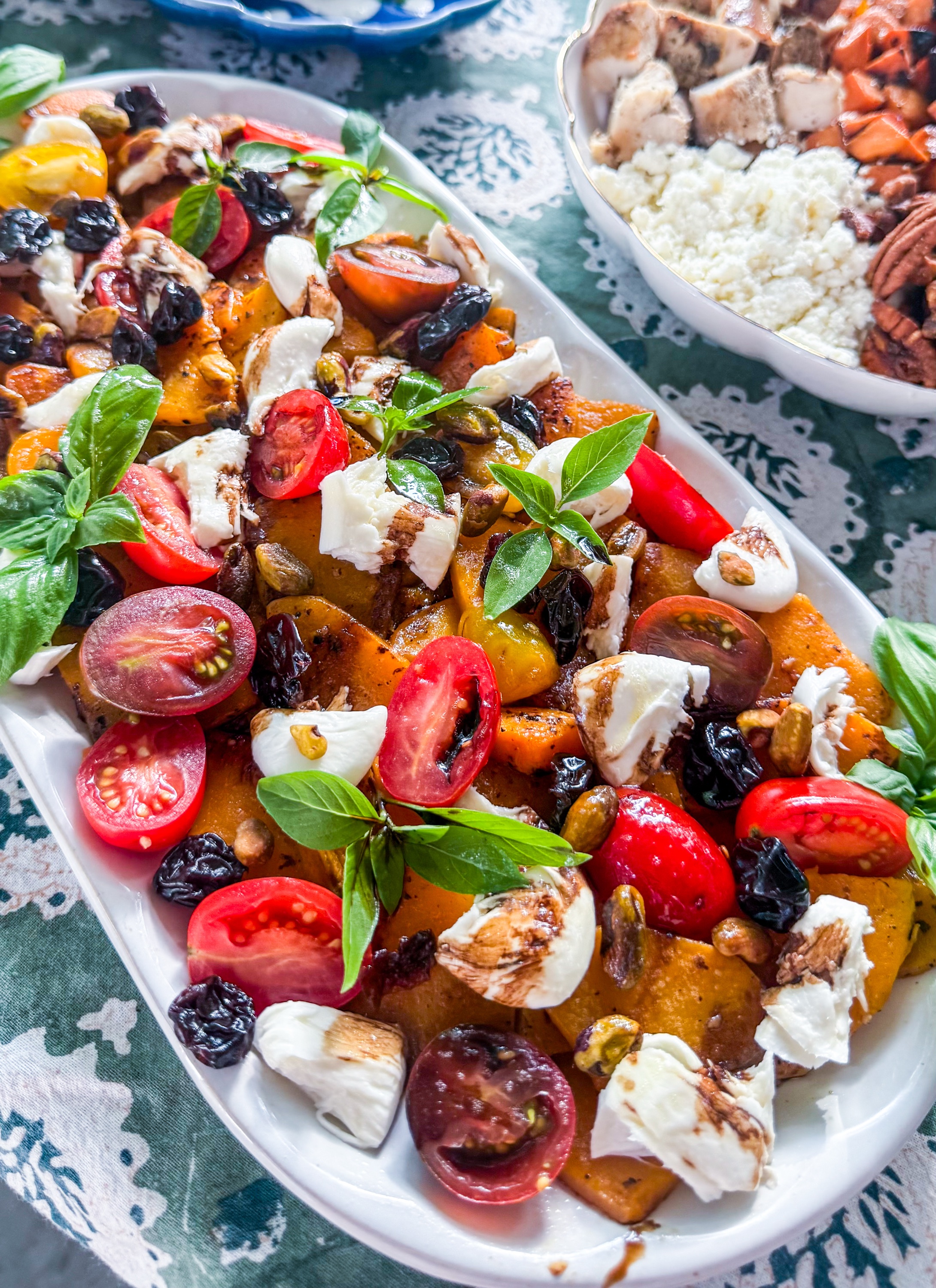 Fall Caprese Bruschetta - Roasted butternut squash, fresh mozzarella, cherry tomatoes, dried cherries, basil and toasted pepitas with balsamic vinaigrette, served with grilled bread