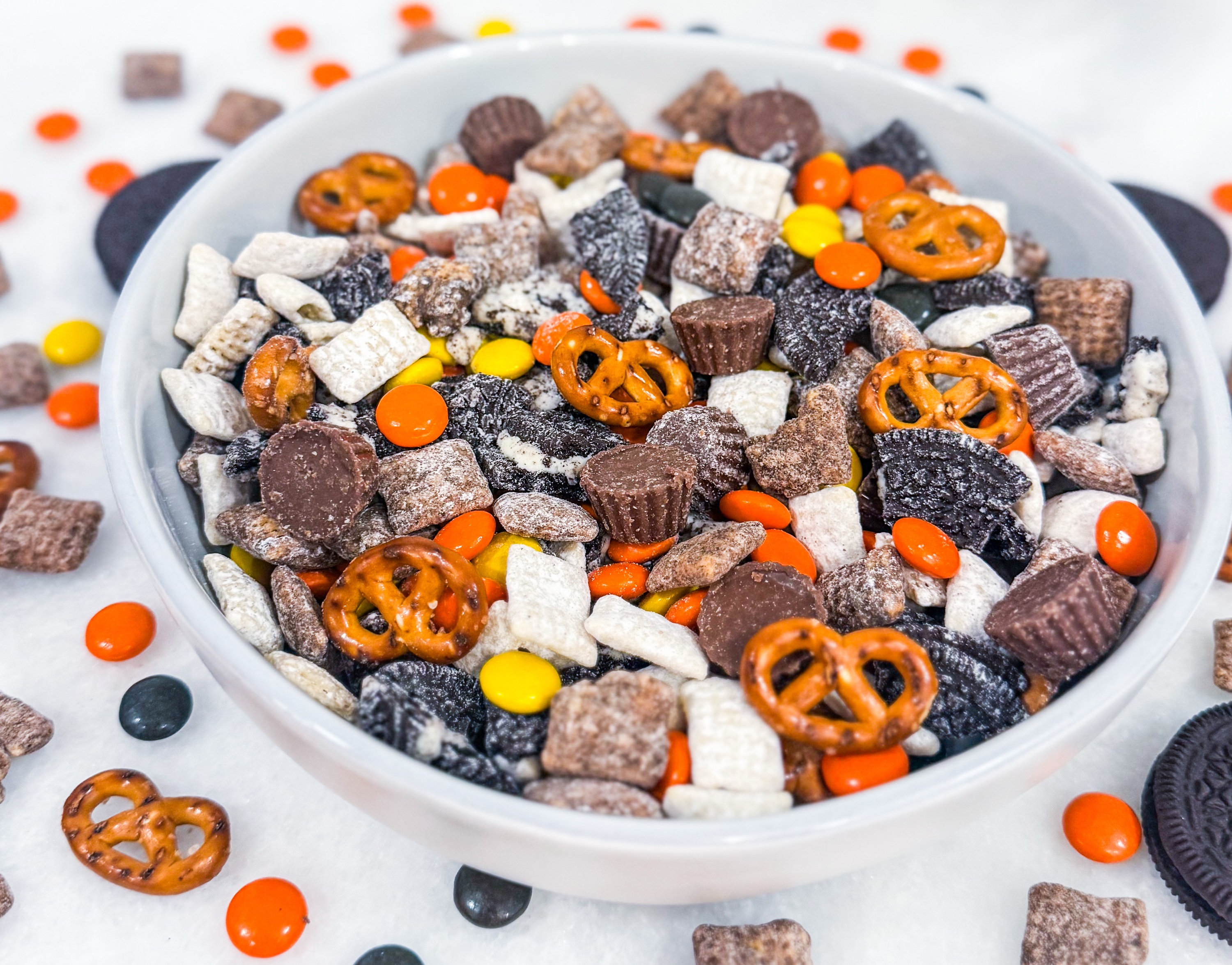 Loaded Muddy Buddies  - White and milk chocolate covered Chex mix loaded with mini Reese’s, Reese’s Pieces, Oreos, pretzels and peanut butter chips