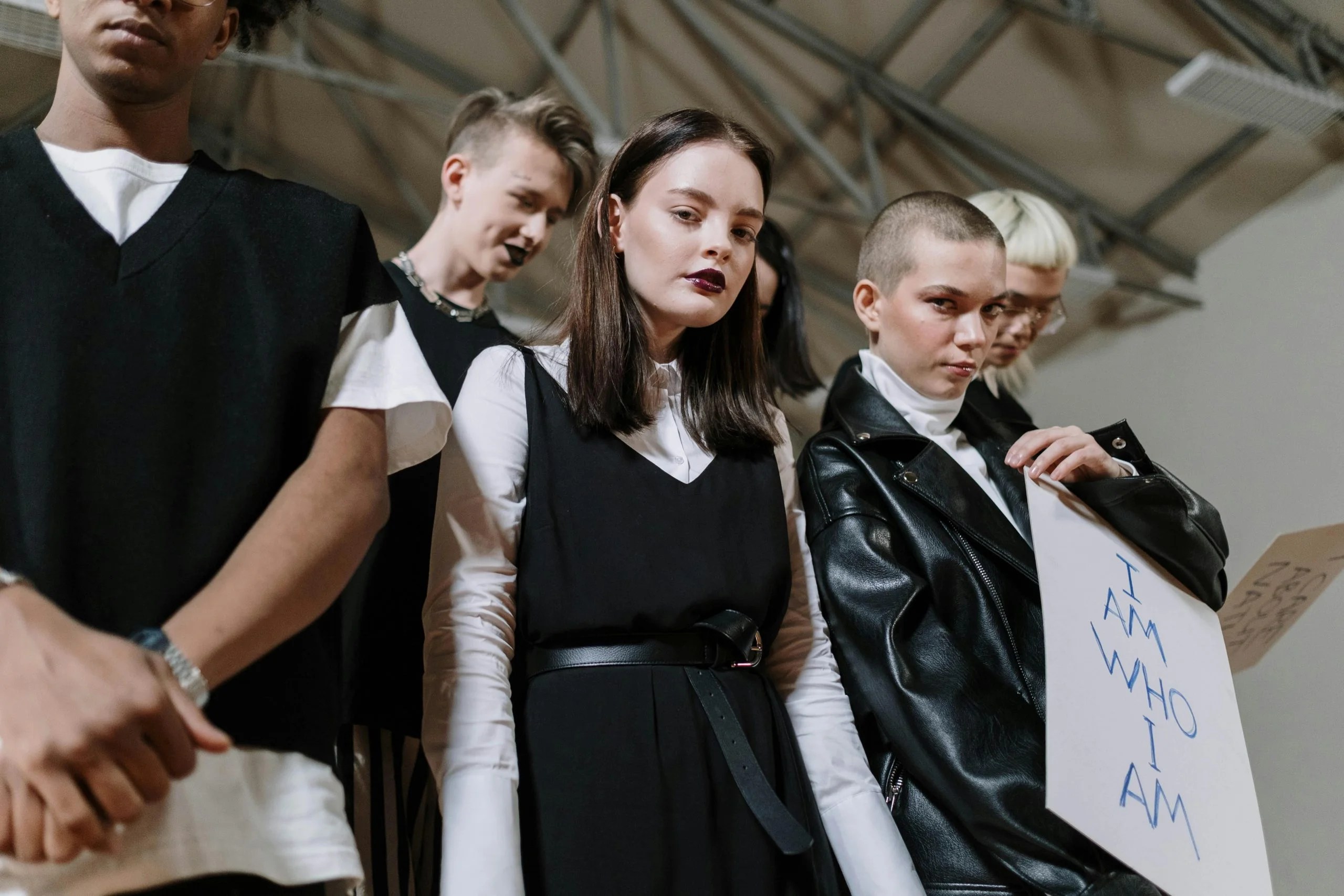 A diverse group of Gen Z individuals showcasing unique style and fashion indoors.