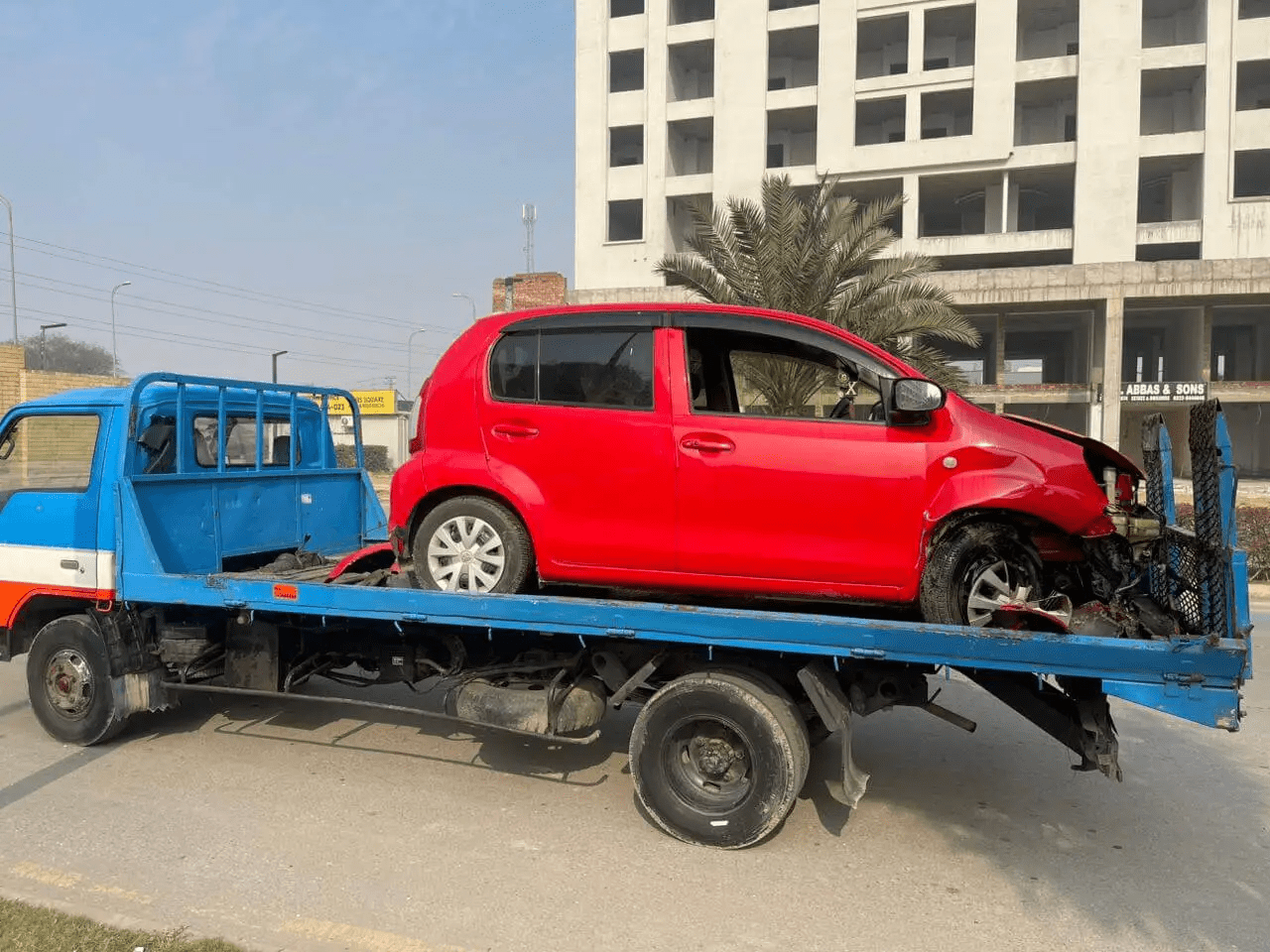 Accident towing documentation in Lahore — Ali Car Towing team photographing vehicle condition at scene