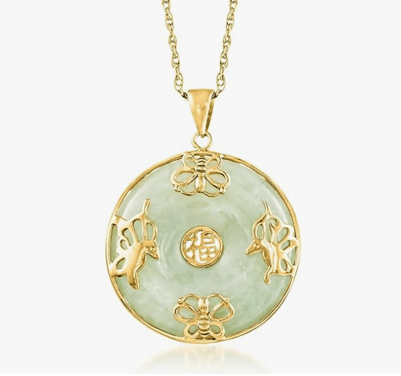 A circular jade pendant adorned with butterfly and unicorn motifs, featuring a gold setting and chain.
