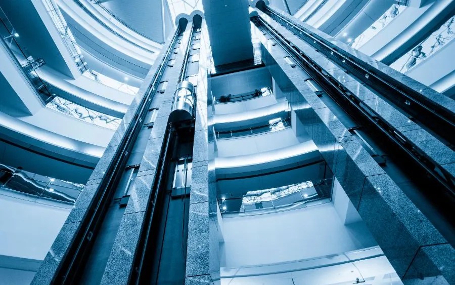 Modern elevator shafts showcasing futuristic smart and sustainable elevator technology