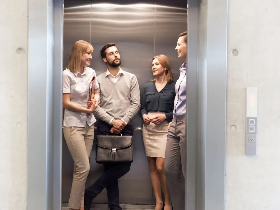 Group of people standing inside an elevator practicing proper etiquette and respectful behavior