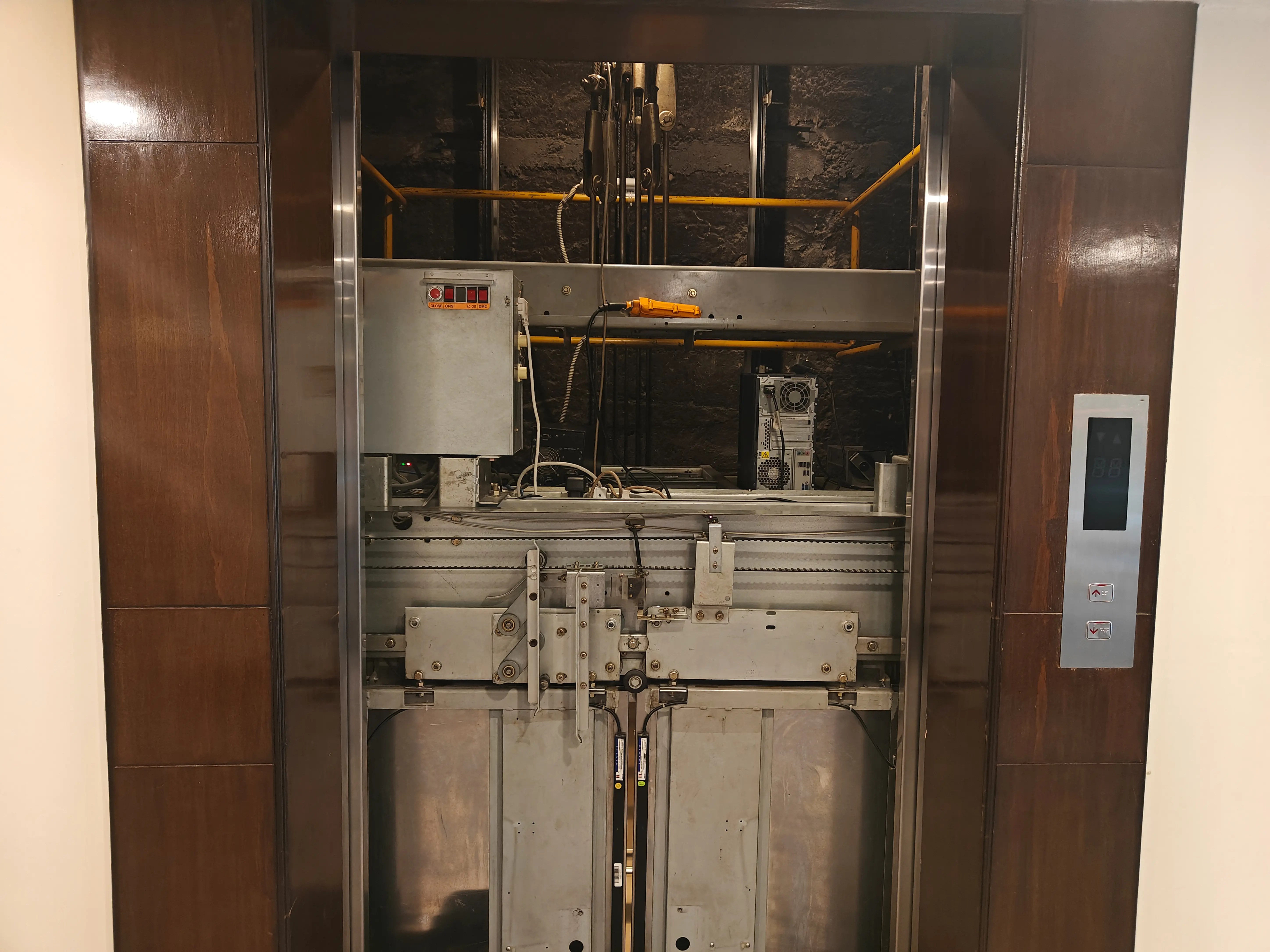 Technician inspecting elevator components for repair in Connecticut