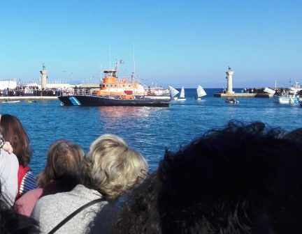 Young men waiting to jump in the water on the lifeboat