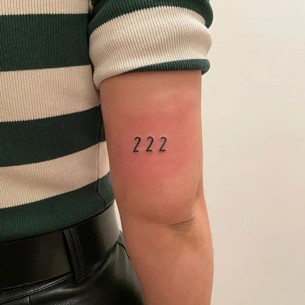 This particular design has digit 222 written in black ink and a unique font. 92 Flattering 222 Tattoos That Will Definitely Change Your Life