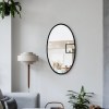 Black Oval Metal Wall Mirror with Wooden Back