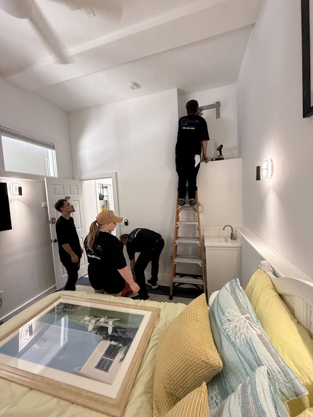 All Phase crew installing a ductless mini split indoor unit